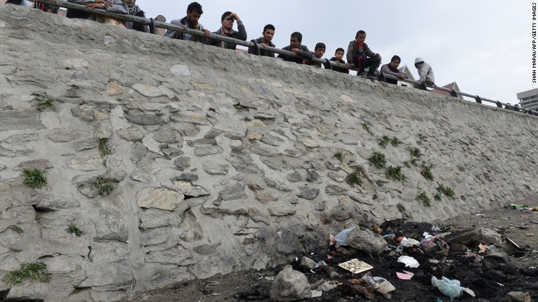 Afghan residents look at the site where an Afghan woman was beaten to death and her body set alight by a mob, in Kabul on March 20, 2015. An Afghan woman was beaten to death and her body was set on fire by a mob in Kabul on March 19 for allegedly burning a copy of the Koran, police officials said. AFP PHOTO / SHAH Marai (Photo credit should read SHAH MARAI/AFP/Getty Images)