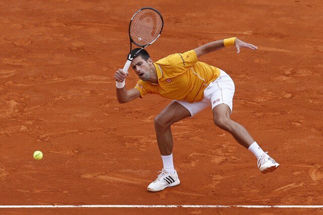 Serbian player Novak Djokovic hits a return to Czech Republic's Tomas Berdych during the Monte-Carlo ATP Masters Series Tournament final tennis match, on April 19, 2015 in Monaco.  AFP PHOTO / VALERY HACHE